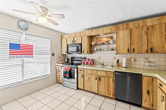 kitchen featuring sink, tasteful backsplash, a healthy amount of sunlight, and black appliances