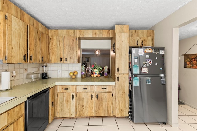 kitchen featuring black dishwasher, stainless steel fridge, a textured ceiling, decorative backsplash, and light tile patterned floors