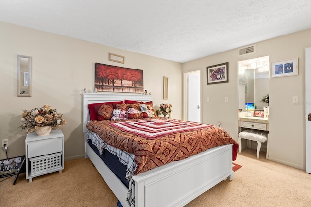 carpeted bedroom with a textured ceiling