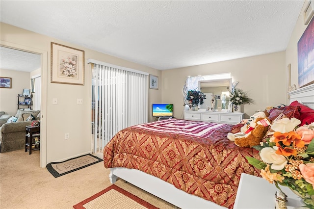 bedroom featuring light carpet and a textured ceiling