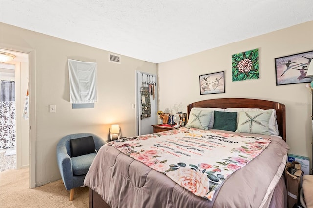 carpeted bedroom featuring a textured ceiling