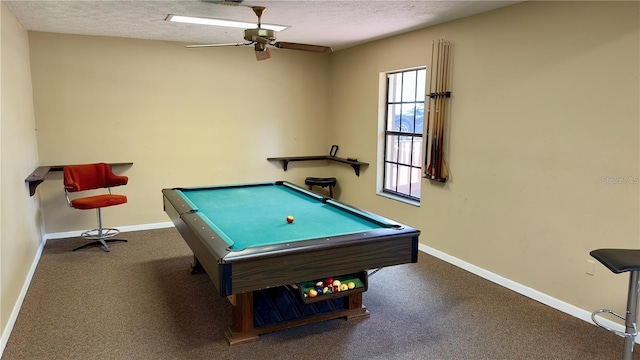 rec room featuring ceiling fan, dark carpet, a textured ceiling, and pool table