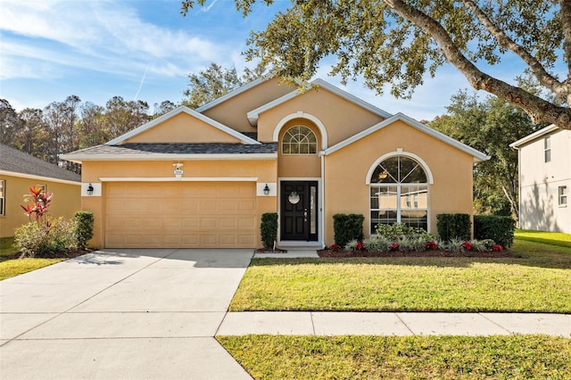 view of front of property featuring a front lawn and a garage