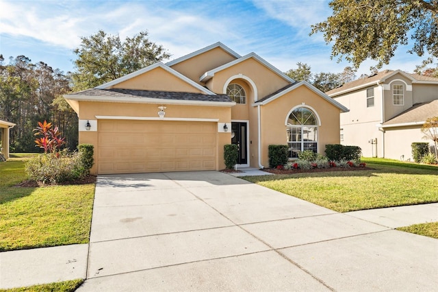 view of front of home featuring a garage and a front lawn