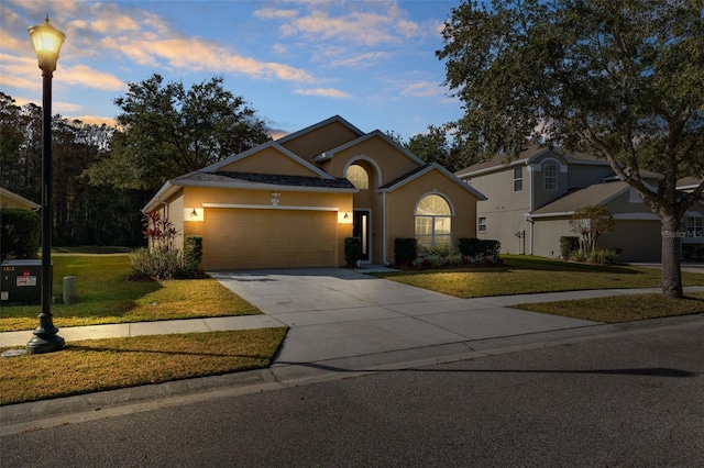 view of front facade featuring a garage and a lawn