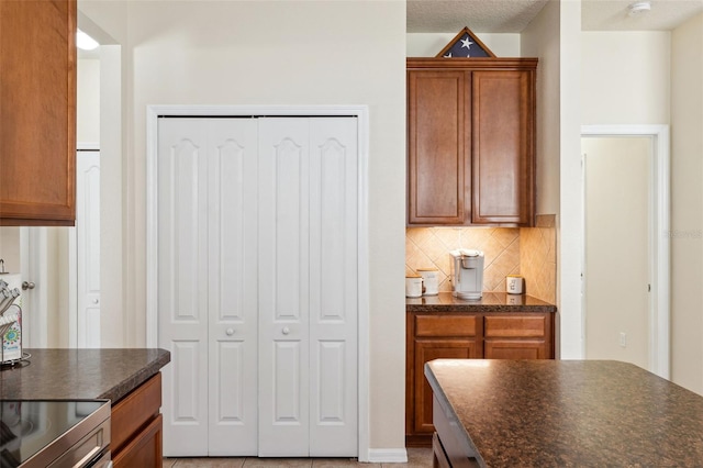 kitchen featuring backsplash and a textured ceiling