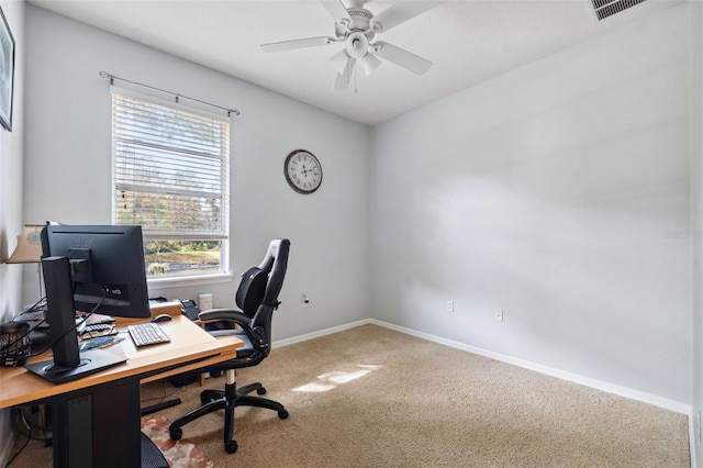 carpeted home office with ceiling fan