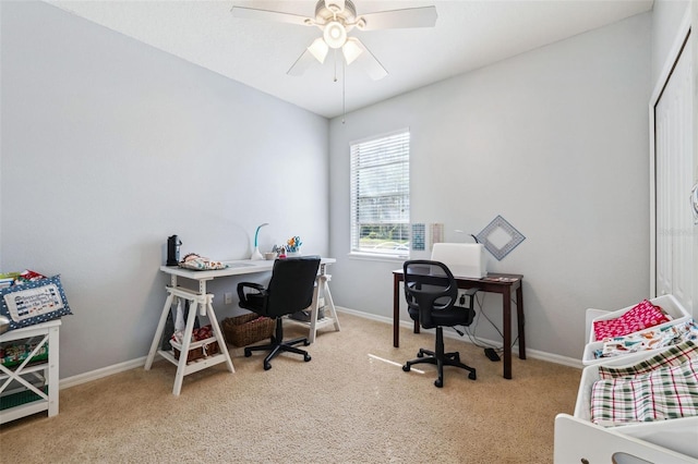 office space featuring ceiling fan and light colored carpet