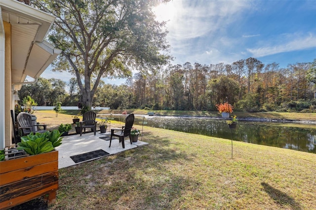 view of yard featuring a water view and a patio area