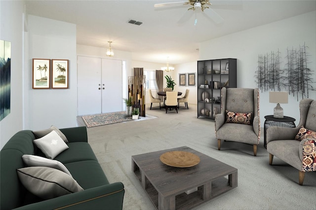 living room featuring ceiling fan with notable chandelier and light colored carpet