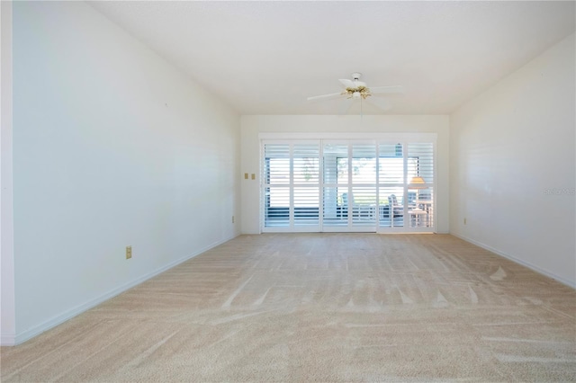 empty room featuring ceiling fan and light colored carpet