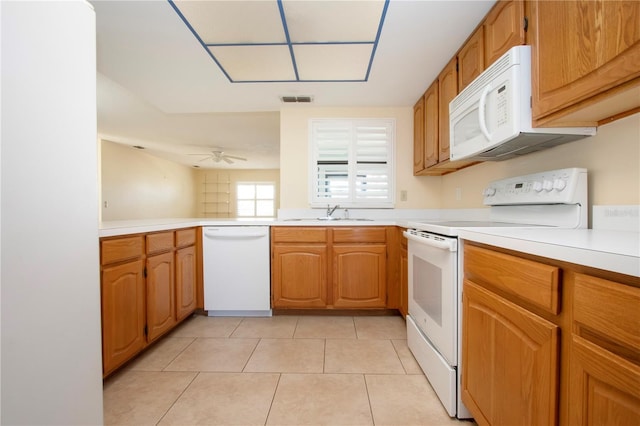 kitchen with light tile patterned floors, white appliances, ceiling fan, and sink