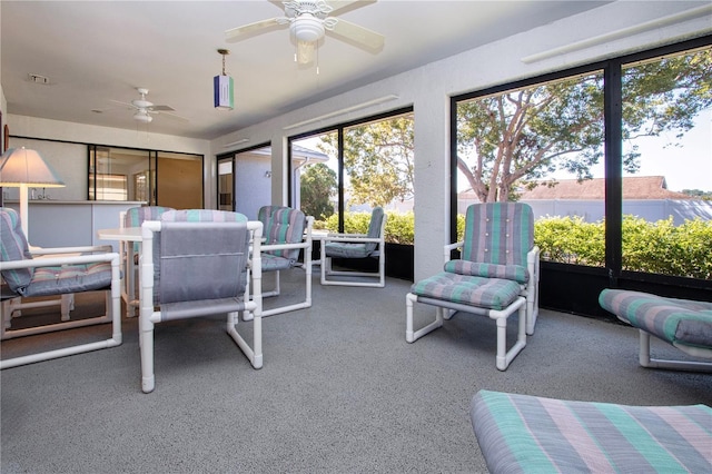 sunroom featuring ceiling fan