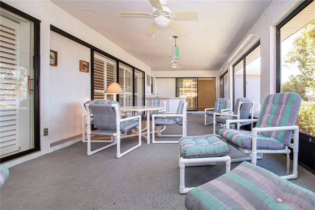 sunroom featuring ceiling fan