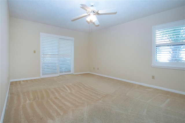 carpeted spare room with ceiling fan