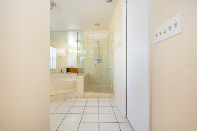 bathroom featuring tile patterned floors and separate shower and tub