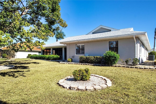 single story home featuring a front yard and a sunroom