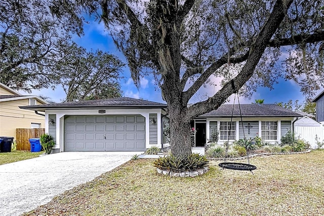 single story home featuring a garage and a front yard