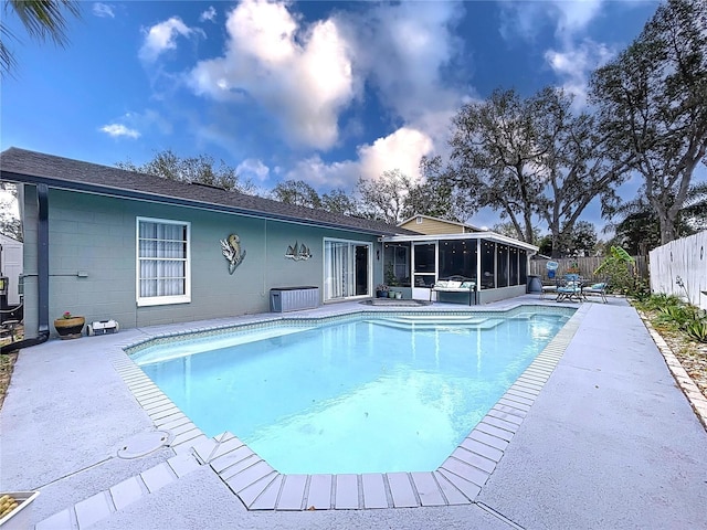 view of pool featuring a sunroom and a patio area