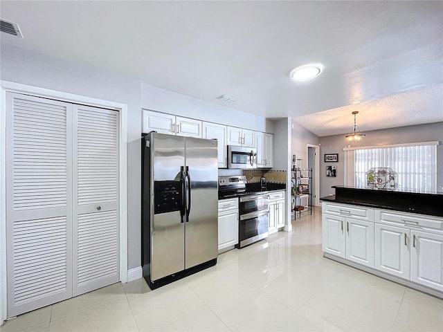 kitchen with light tile patterned flooring, pendant lighting, white cabinets, and stainless steel appliances