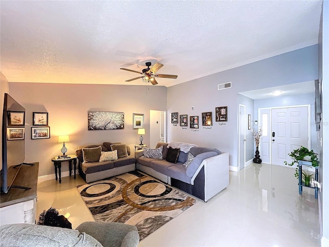 living room featuring ceiling fan and a textured ceiling