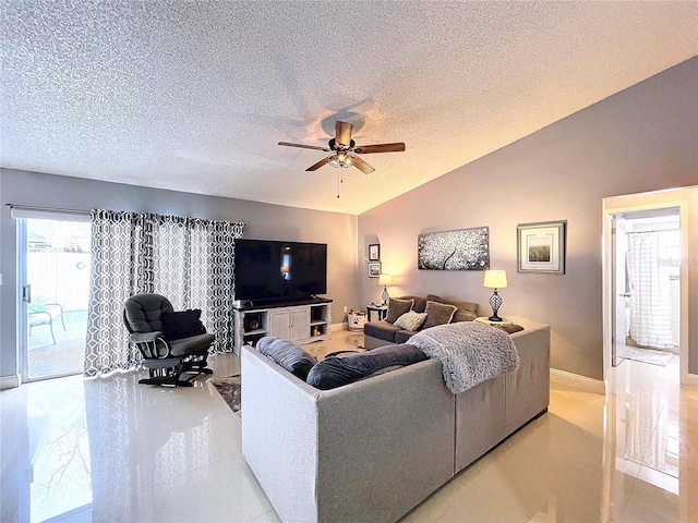 living room featuring lofted ceiling, ceiling fan, and a textured ceiling