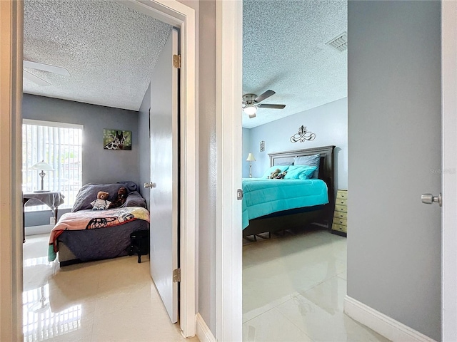 bedroom featuring a textured ceiling and ceiling fan