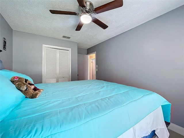 bedroom with ceiling fan, a textured ceiling, and a closet