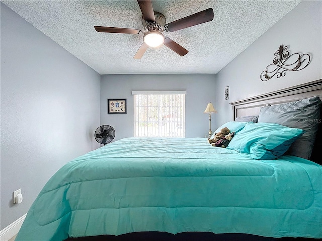 bedroom with a textured ceiling and ceiling fan