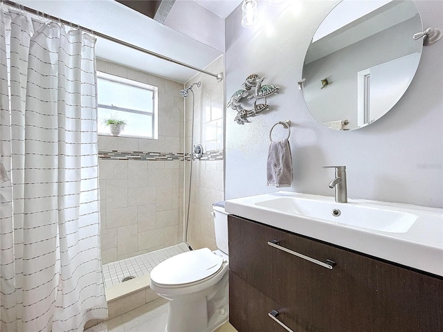 bathroom featuring tile patterned flooring, a shower with curtain, vanity, and toilet