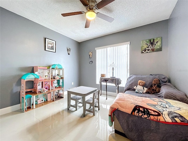 tiled bedroom with ceiling fan and a textured ceiling