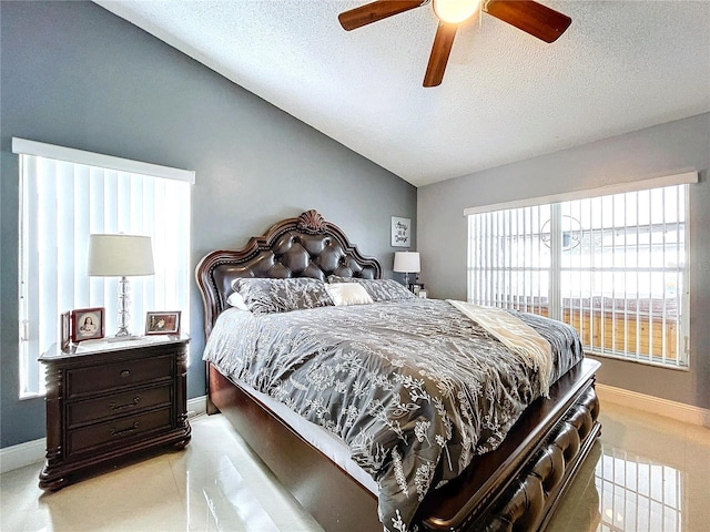 bedroom featuring a textured ceiling, vaulted ceiling, multiple windows, and ceiling fan