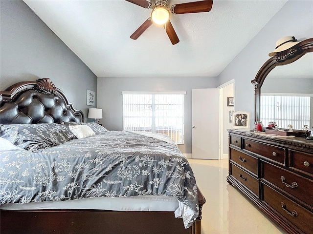 bedroom featuring multiple windows, ceiling fan, and lofted ceiling