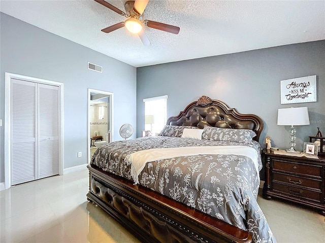 bedroom featuring ceiling fan, a closet, ensuite bathroom, and a textured ceiling