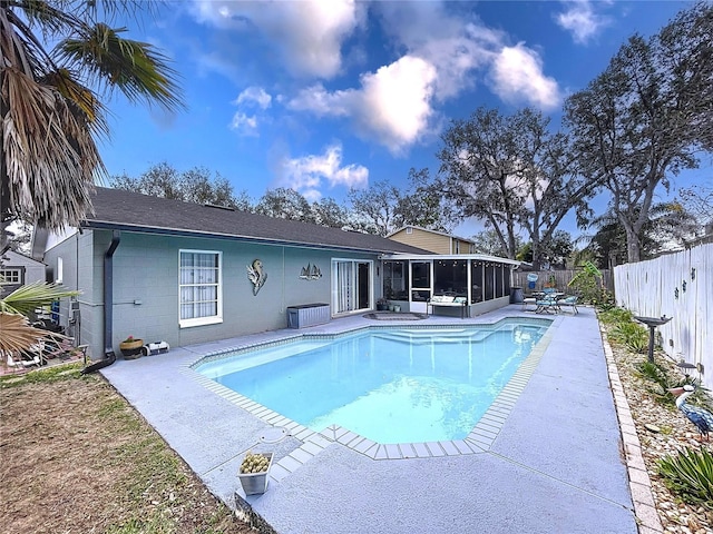 view of swimming pool with a patio area and a sunroom