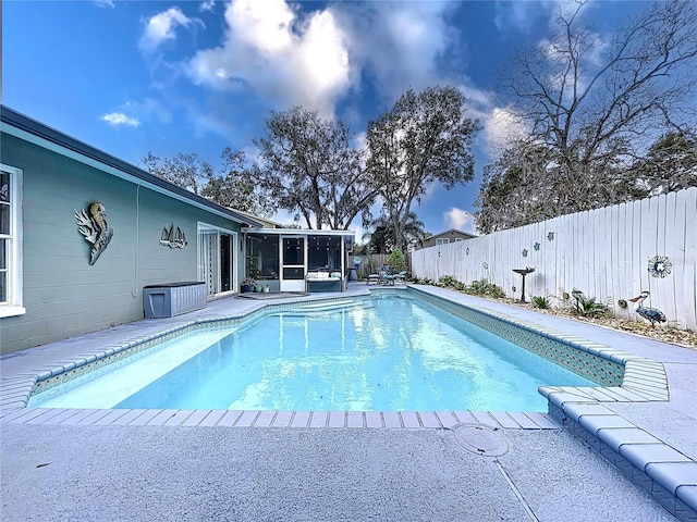 view of swimming pool featuring a sunroom