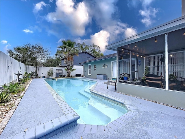 view of pool with a patio area and a sunroom