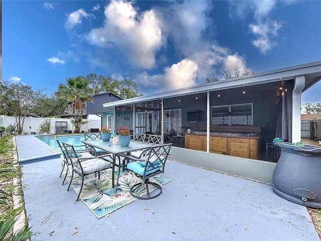 view of patio / terrace with a sunroom and a fenced in pool