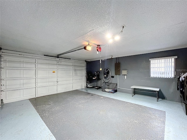 garage featuring electric panel and a garage door opener