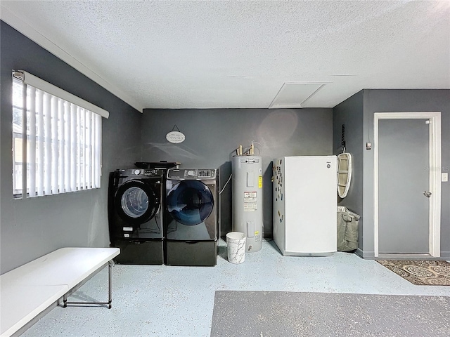 laundry room with water heater, a textured ceiling, and independent washer and dryer