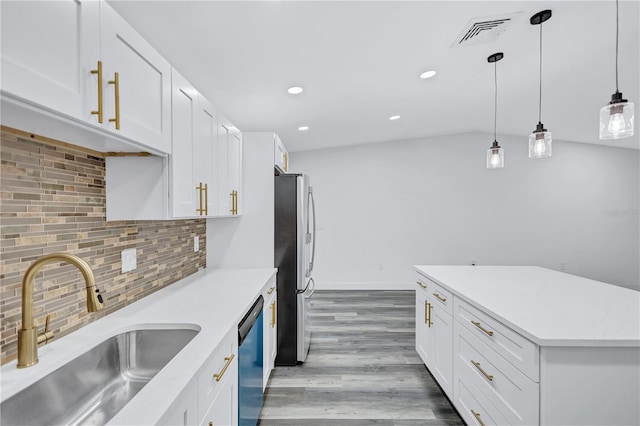 kitchen with pendant lighting, sink, white cabinets, and stainless steel appliances