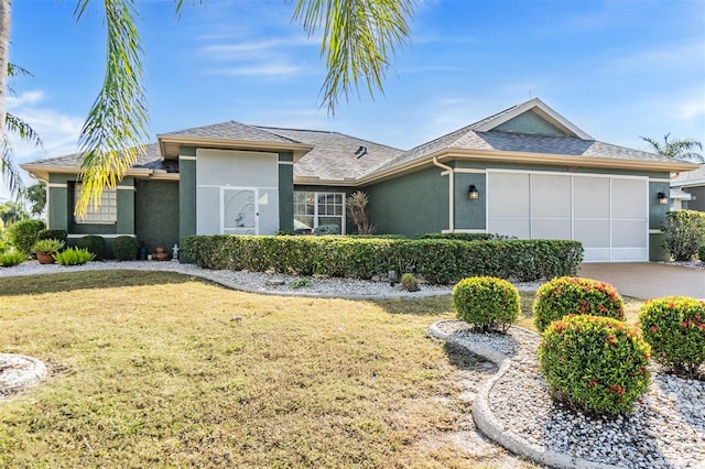 ranch-style home with a front yard and a garage