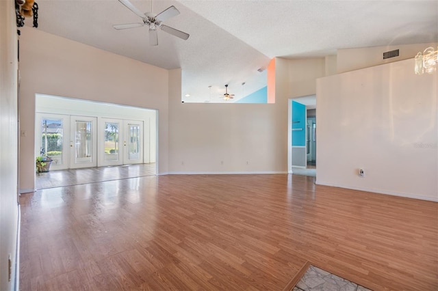 unfurnished living room featuring light hardwood / wood-style flooring, high vaulted ceiling, and ceiling fan