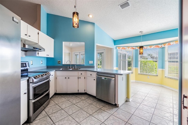 kitchen with white cabinets, pendant lighting, kitchen peninsula, and appliances with stainless steel finishes