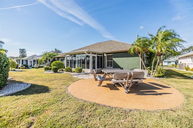 back of property featuring a lawn, central AC, a sunroom, and a patio area