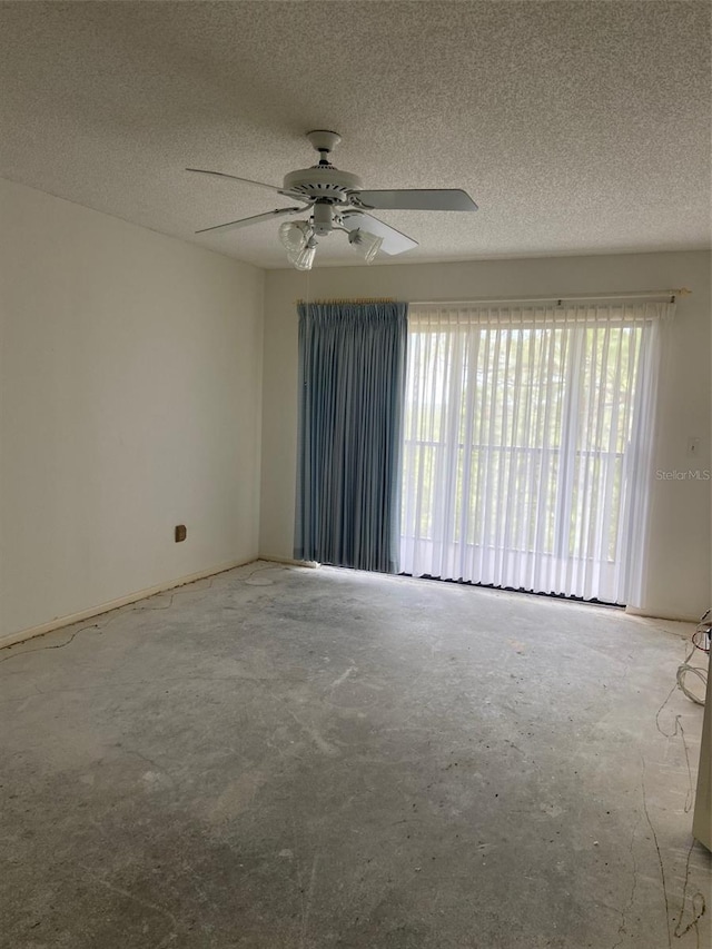 empty room with a textured ceiling and ceiling fan