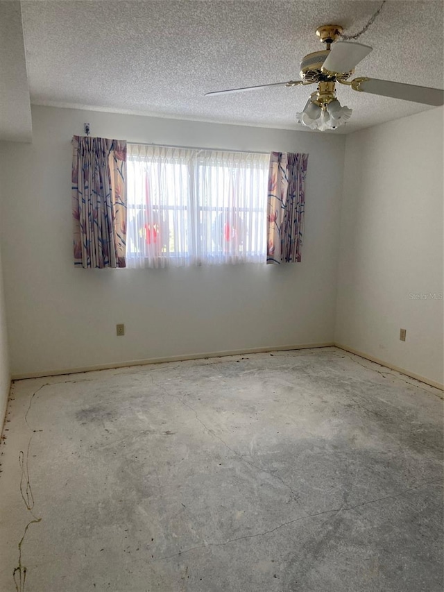 spare room featuring ceiling fan and a textured ceiling