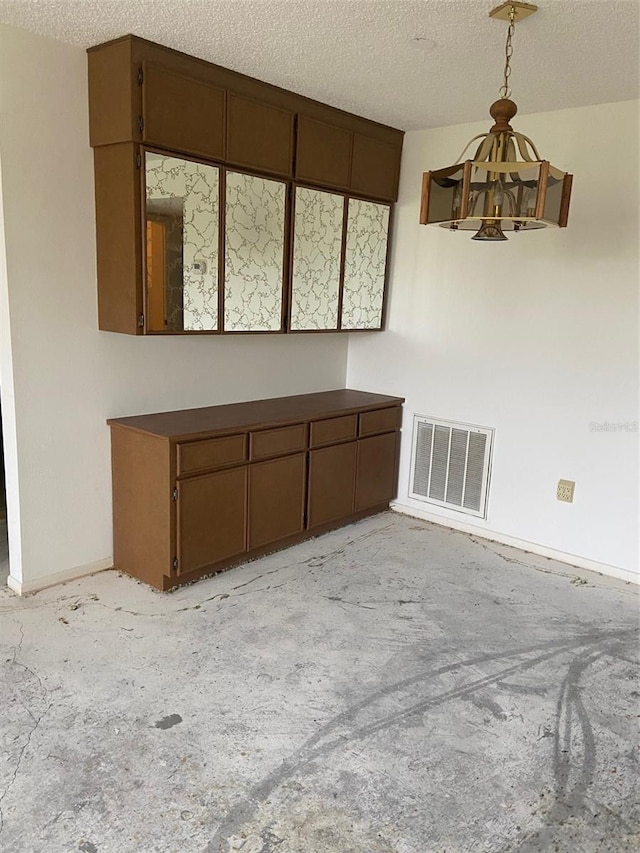 interior space with light colored carpet and a textured ceiling