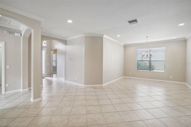 empty room featuring light tile patterned floors, baseboards, visible vents, arched walkways, and crown molding