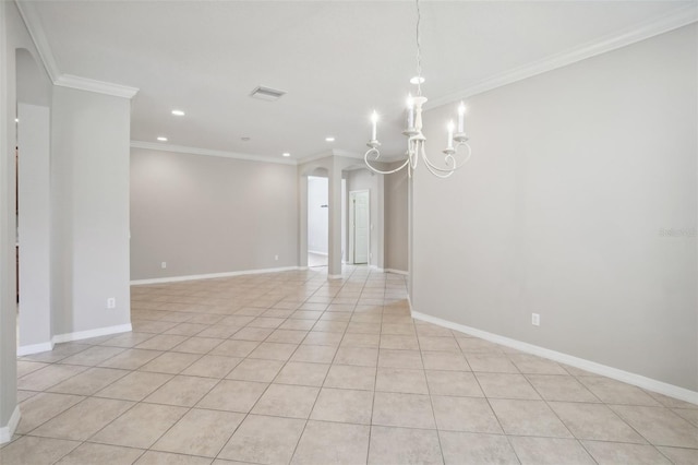 empty room featuring light tile patterned flooring, a notable chandelier, and ornamental molding